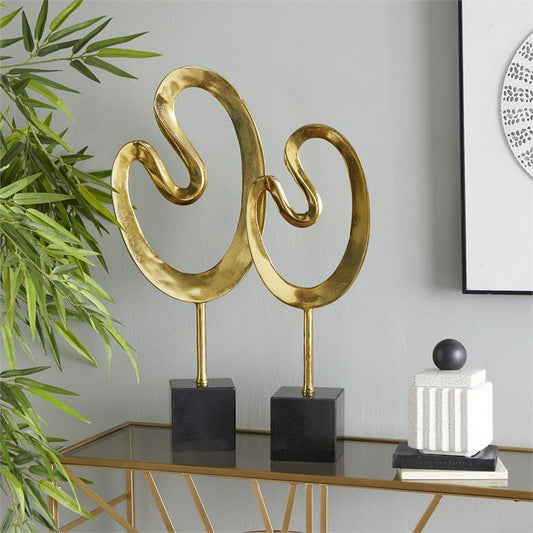 COSMOLIVING BY COSMOPOLITAN GOLD MARBLE ABSTRACT SCULPTURE WITH BLACK BASE